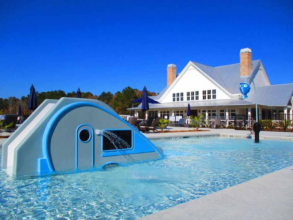 A slide that looks like a RV in the pool at CREEKFIRE RESORT