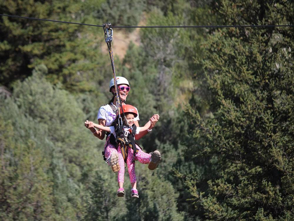 A lady and her daughter ziplining