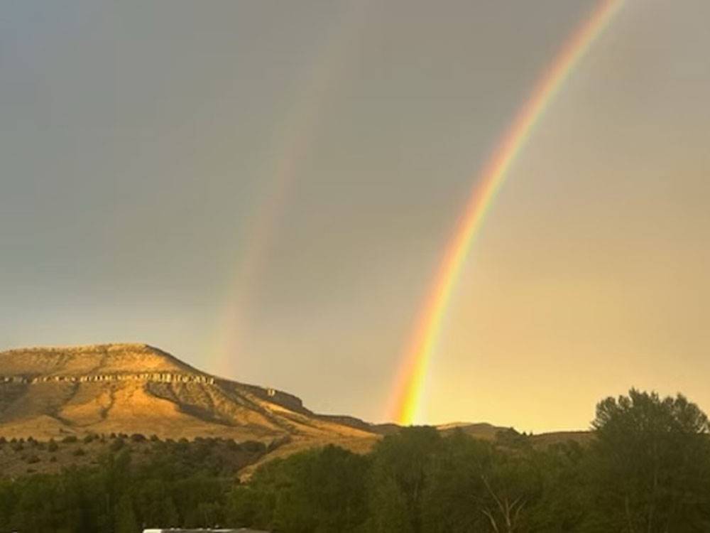 A rainbow behind the mountain nearby