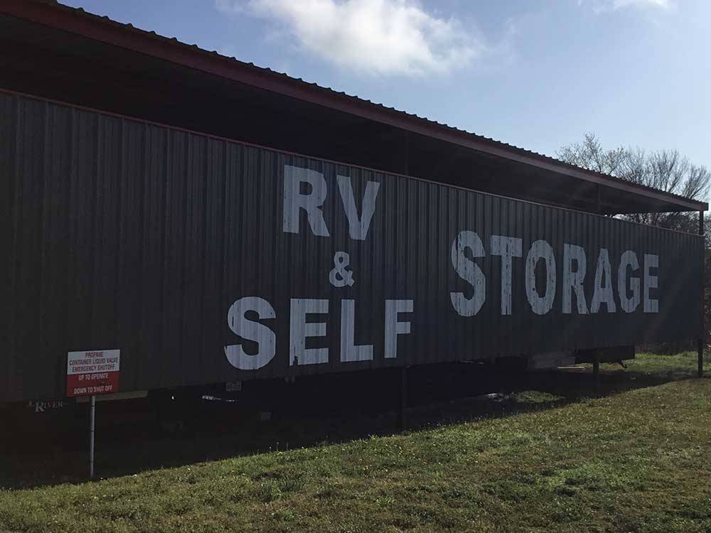 RV & Self Storage painted on the side of the building at VALLEY ROSE RV PARK
