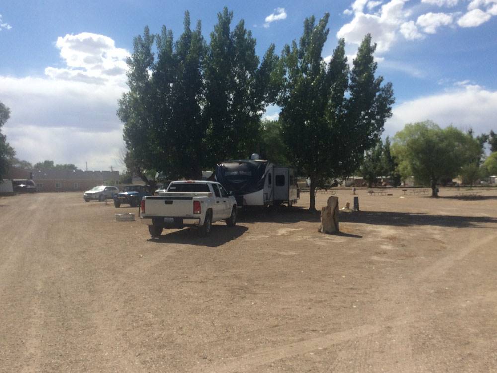 A truck parked in front of a trailer
