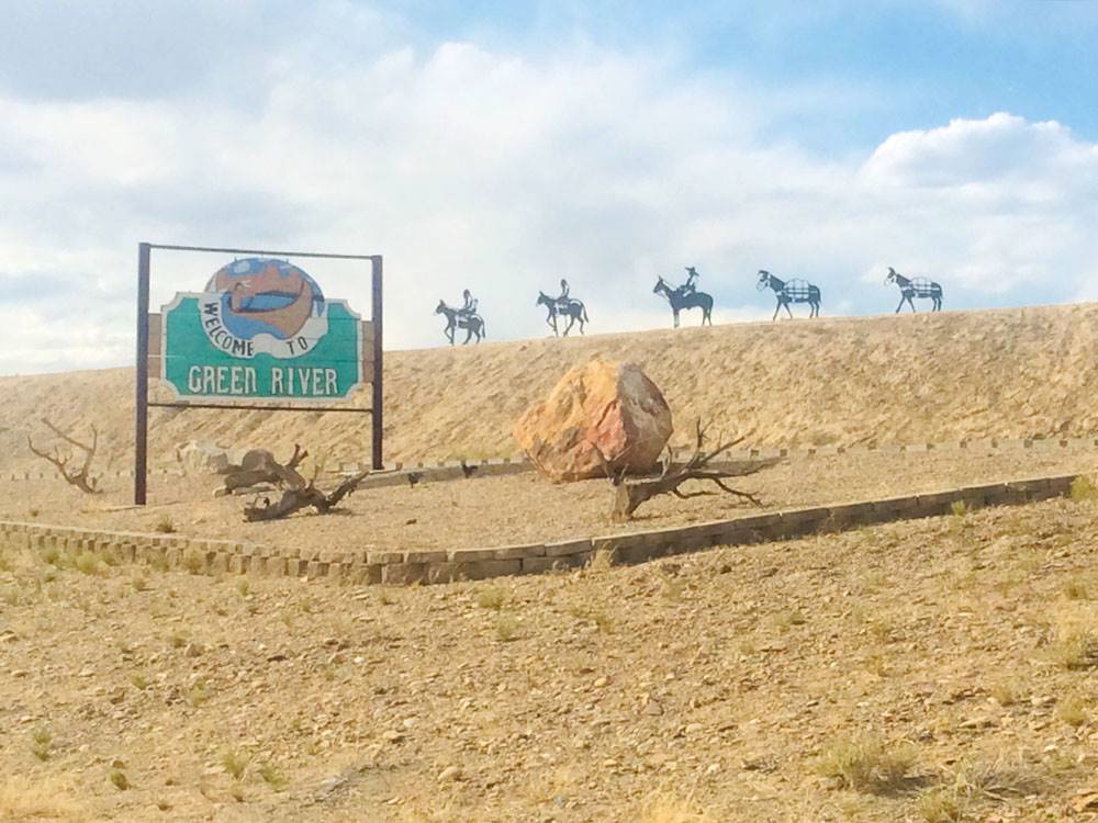 Five horse statues by a sign