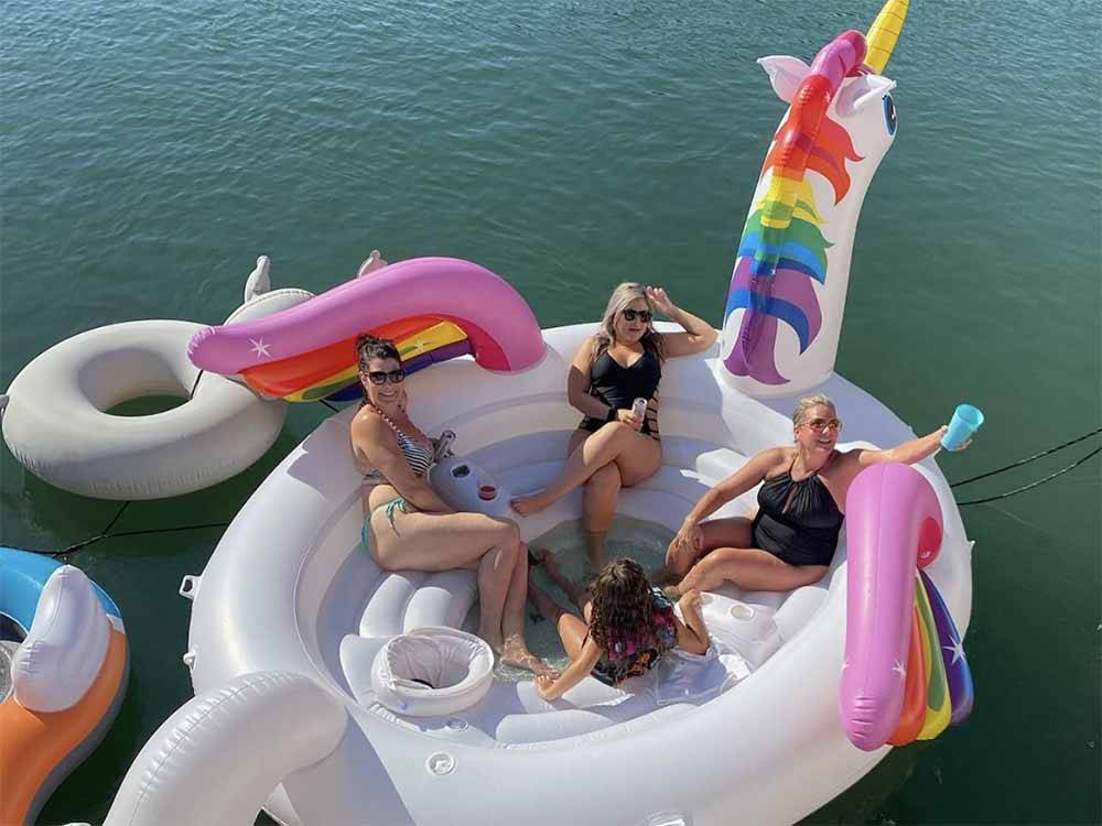A group of women sitting in a floating unicorn at KO-KET RESORT