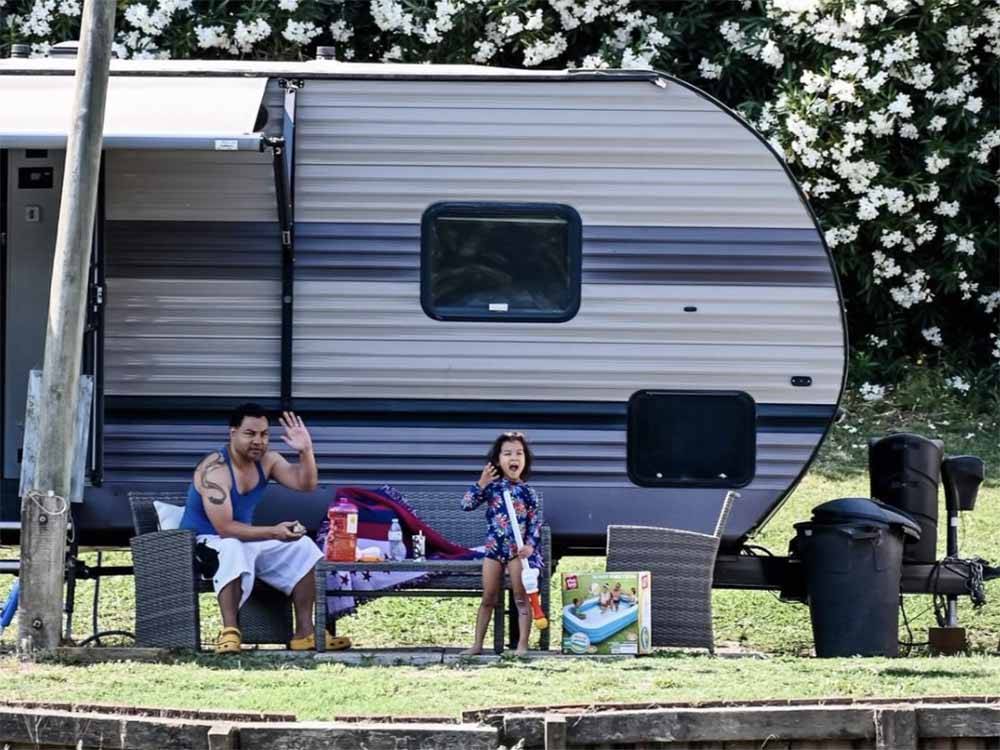 A father and daughter next to a trailer at KO-KET RESORT