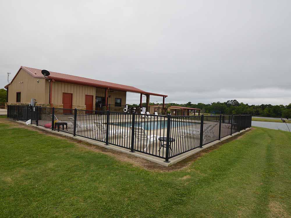 The fenced in swimming pool at EAST FORK RV RESORT