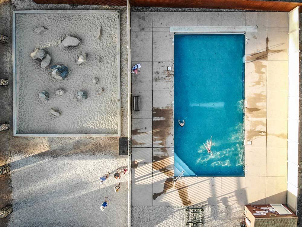 An aerial view of the swimming pool at PALISADE BASECAMP RV RESORT