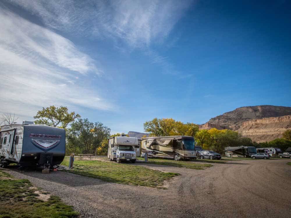 RVs parked at campground sites at PALISADE BASECAMP RV RESORT