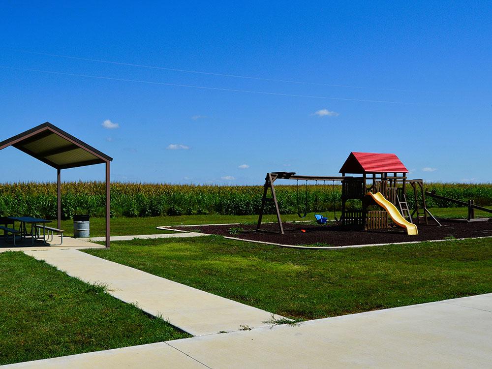 The playground and covered seating area at TEXAS RANCH RV RESORT