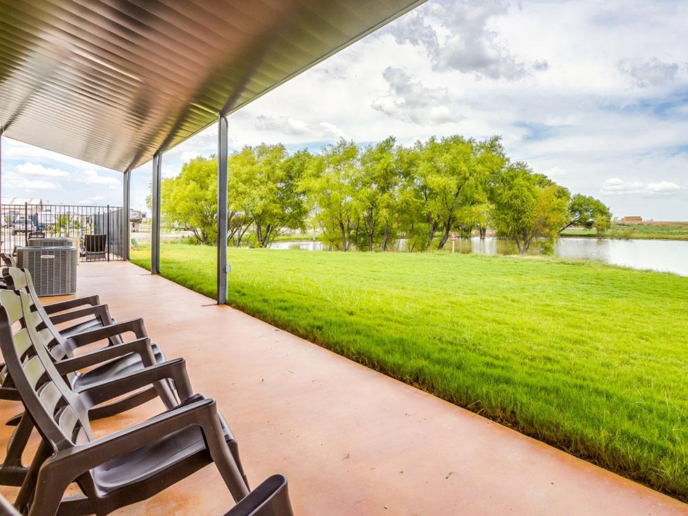 Rocking chairs overlooking the pond at TEXAS RANCH RV RESORT