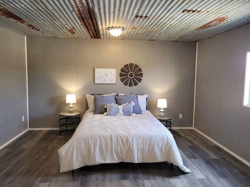 A view of the bedroom in the cabin at HIDDEN LAKE RV RANCH & SAFARI