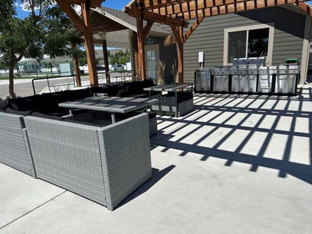 Outdoor pergola with bbq pits and tables at ASPEN GROVE RV PARK