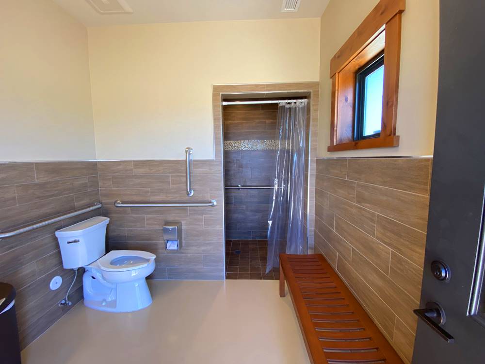 Very clean restroom with a shower at GRAND PLATEAU RV RESORT AT KANAB