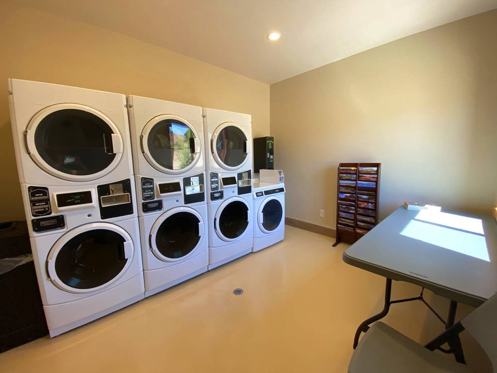 Laundry room with washing machines and dryers at GRAND PLATEAU RV RESORT AT KANAB