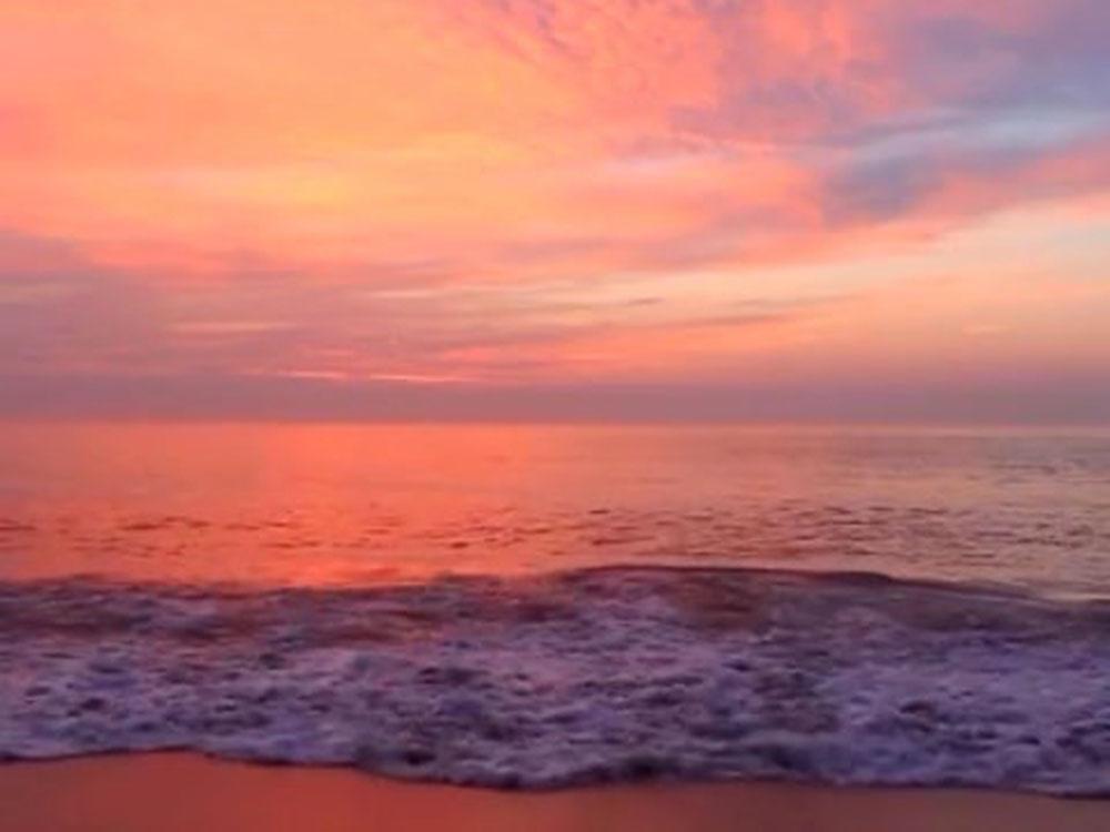 Beach at sunset at TROPIC ISLAND RESORT