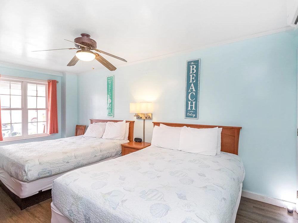 Two queen beds inside a rental at TROPIC ISLAND RESORT