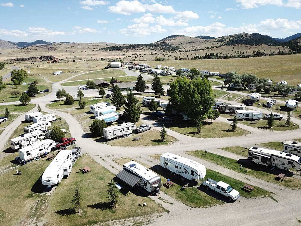 Drone view of grassy park with gravel sites at FAIRMONT RV RESORT