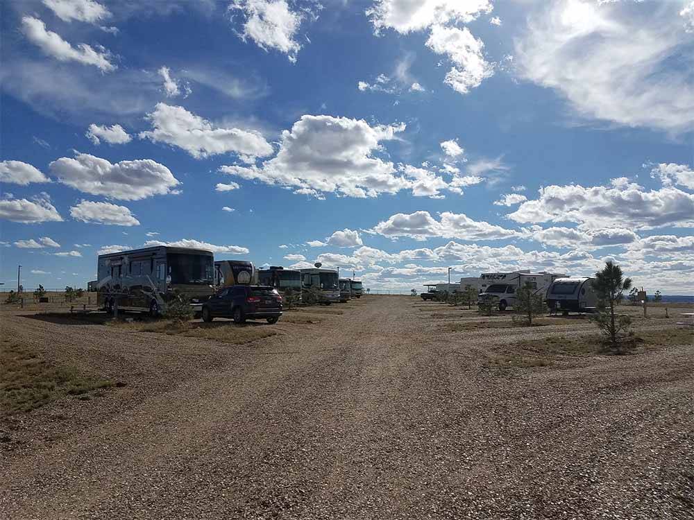 A row of gravel RV sites at CUERVO MOUNTAIN RV PARK AND HORSE HOTEL