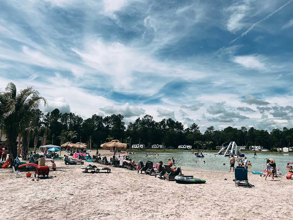 A group of people on the beach at ISLAND OAKS RV RESORT