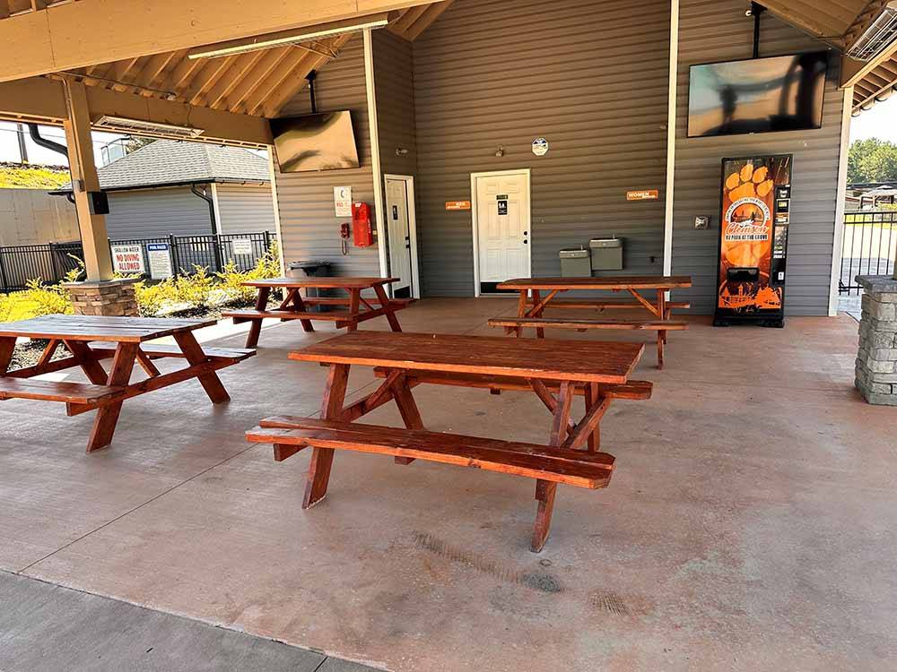 An outdoor dining area with flat screen TVs at CLEMSON RV PARK AT THE GROVE