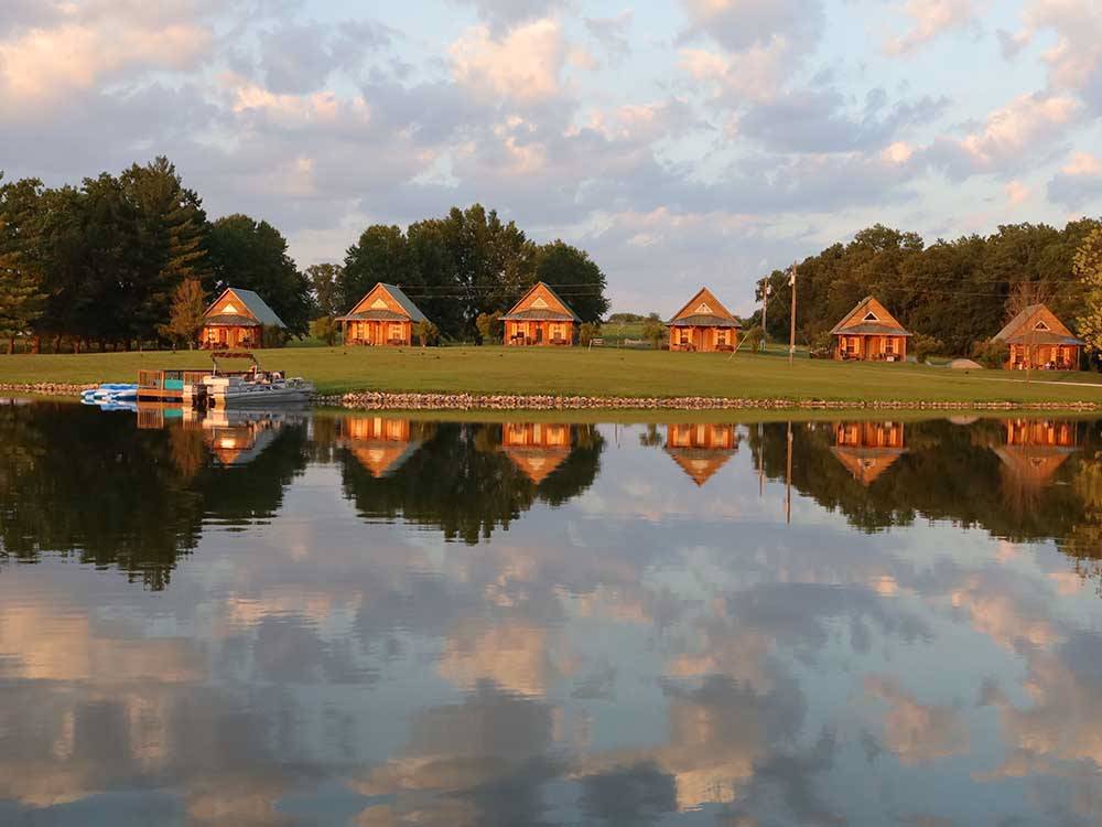 View from the water of cabins at CEDAR CREEK RESORT & RV PARK