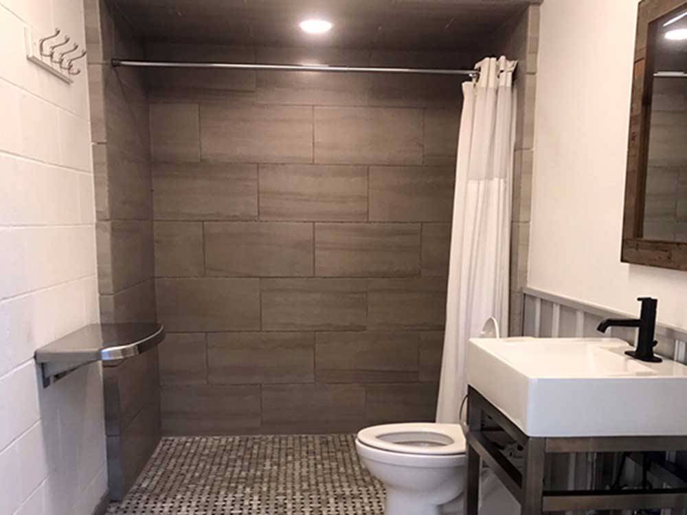 A bathroom with shower stall at CALYPSO COVE RV PARK
