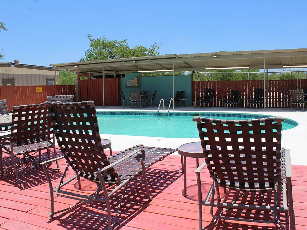 Lounge chairs at the pool at Cotulla Camp Resort