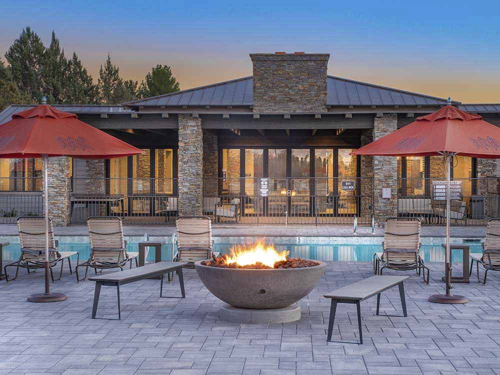 A fire pit in front of the pool at VERDE RANCH RV RESORT