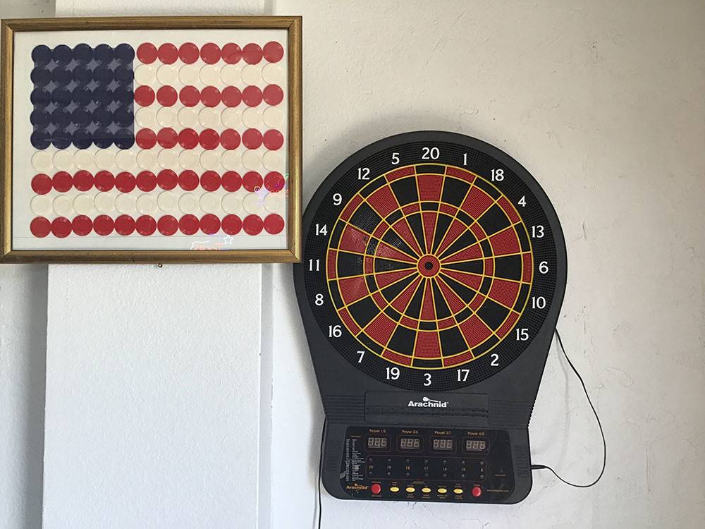 Dart board and American flag decor at Amigo Inn & RV Park