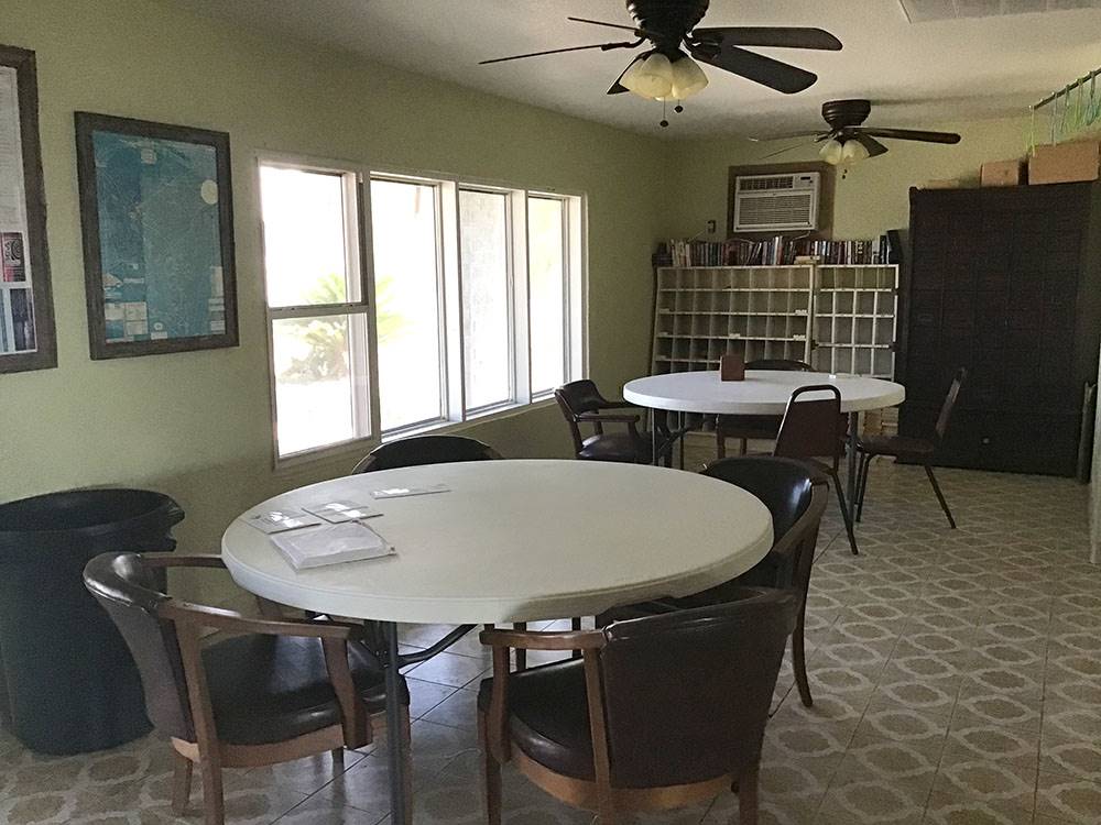 A room with round tables and chairs at Amigo Inn & RV Park