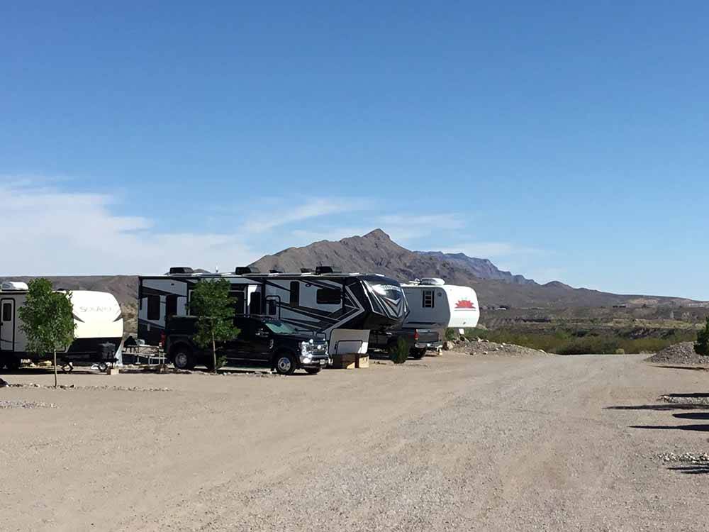 RV sites with mountains in the background at DESERT VIEW RV PARK
