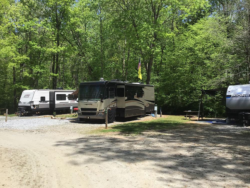 A motorhome and trailer parked in gravel sites at JENNY'S CREEK FAMILY CAMPGROUND