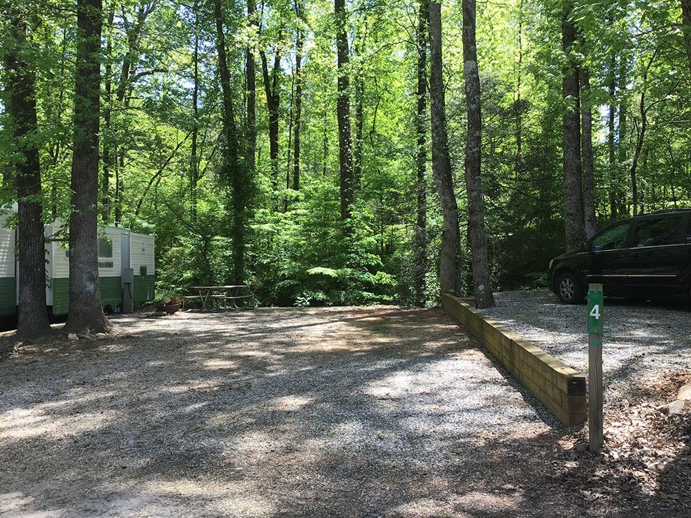 One of the gravel sites surrounded by tall trees at JENNY'S CREEK FAMILY CAMPGROUND