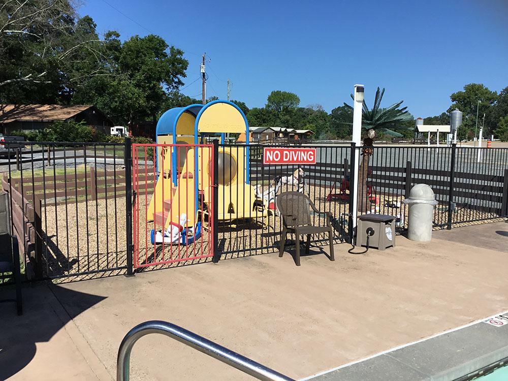 A view of the playground from the pool at TEXARKANA RV PARK