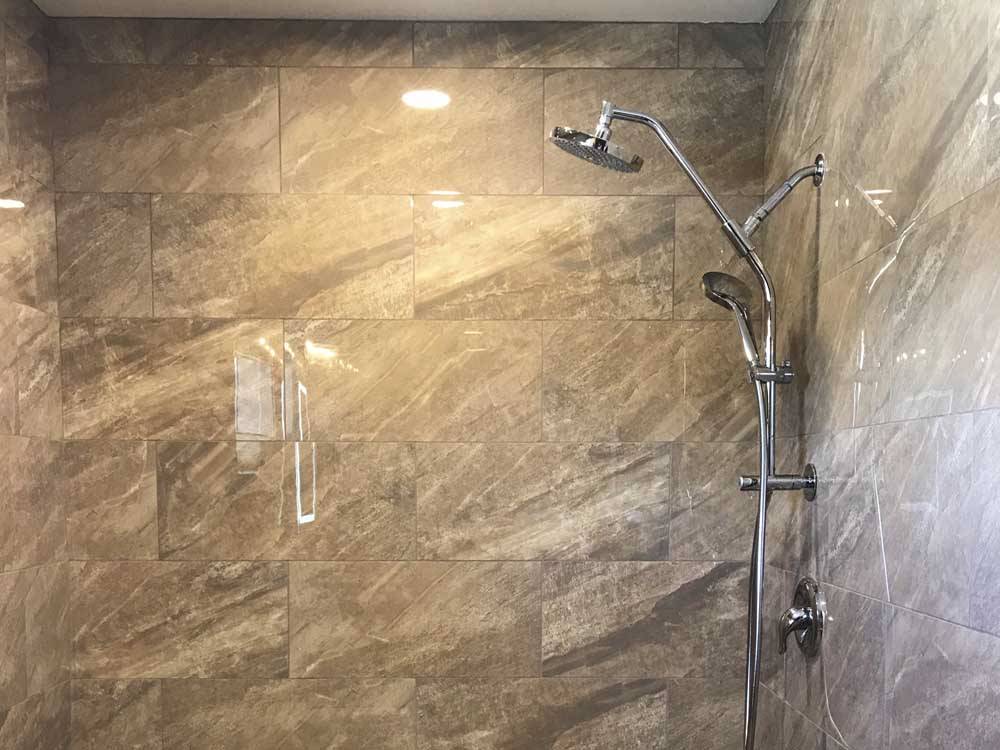 Inside of the clean and modern showers at IRON SPRINGS ADVENTURE RESORT