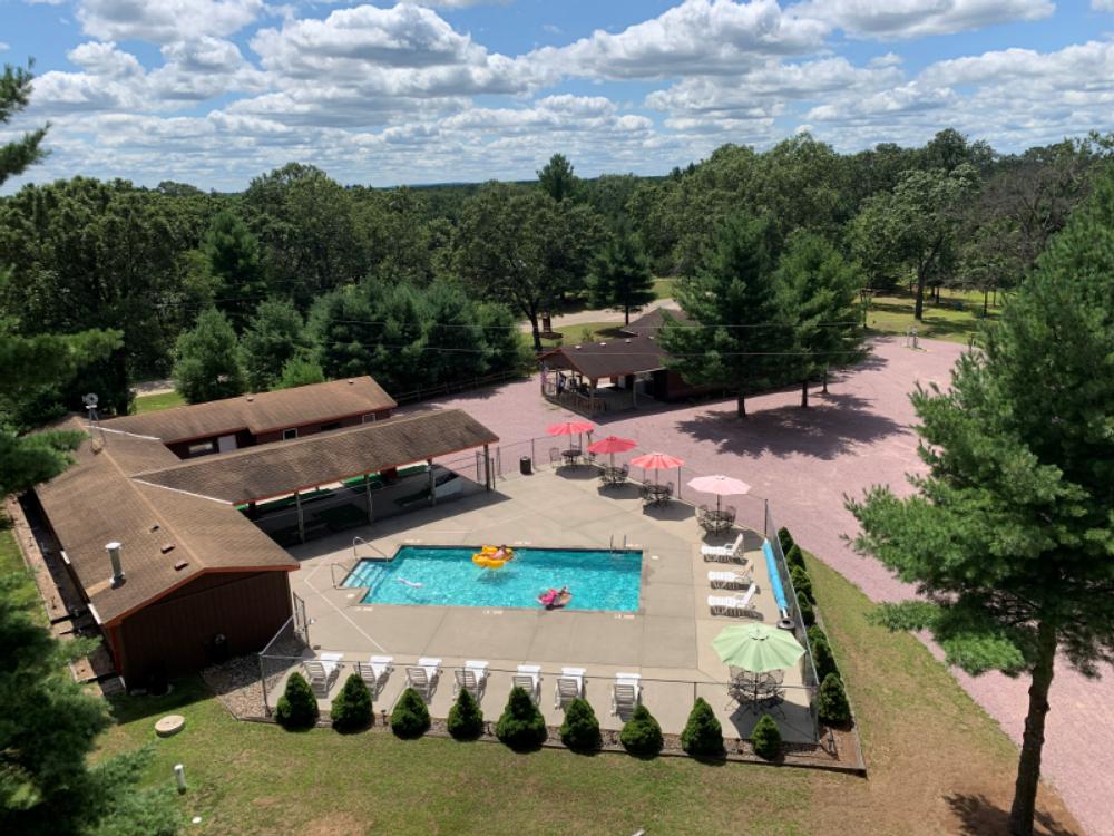 Aerial shot of wooded area and pool at Dells Camping Resort