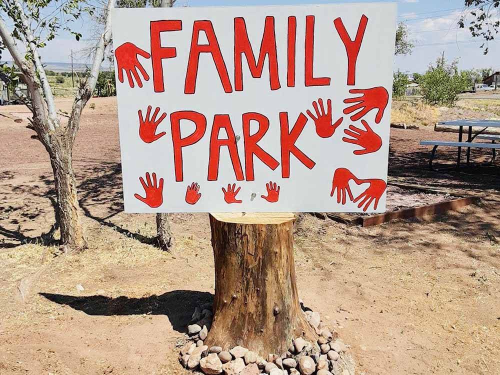 A family park sign on a stump at ST JOHNS RV RESORT