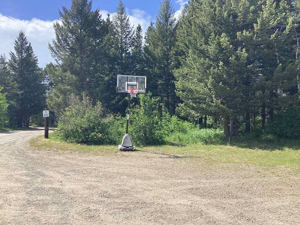 Basketball hoop and dirt court at RED EAGLE CAMPGROUND