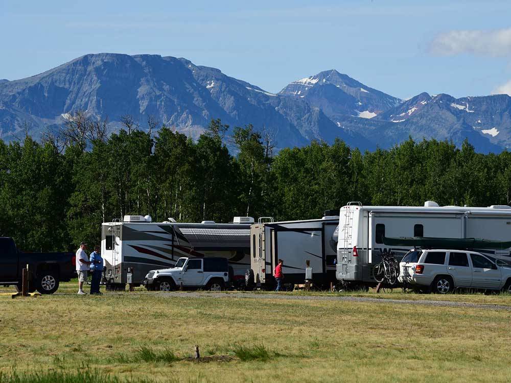 A row of motorhomes in grassy sites at CHEWING BLACK BONES CAMPGROUND