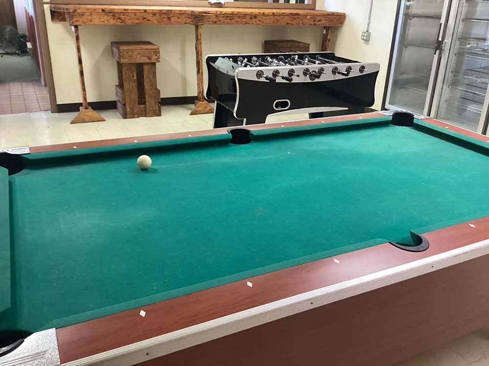 Pool table and foosball table in rec room at CHEWING BLACK BONES CAMPGROUND
