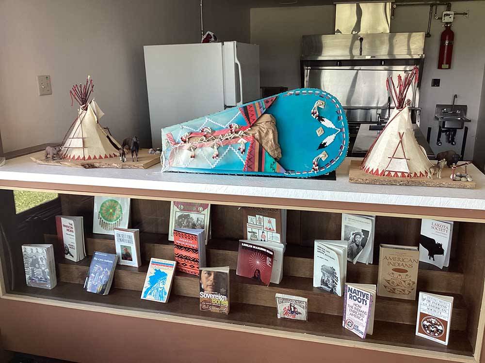 Native American books and diorama on display at CHEWING BLACK BONES CAMPGROUND