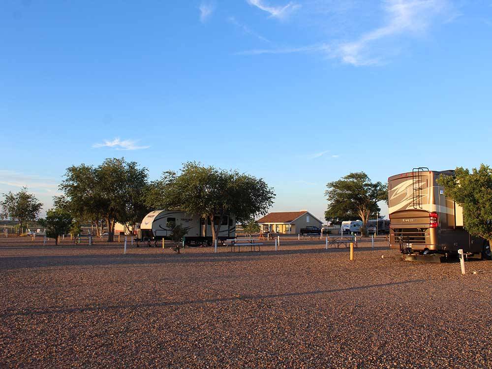 A row of gravel sites with benches at BLAZE-IN-SADDLE RV PARK