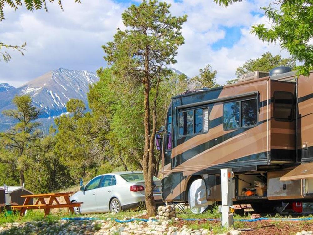 A brown and black motorhome parked in a RV site at BLACK BEAR RETREAT
