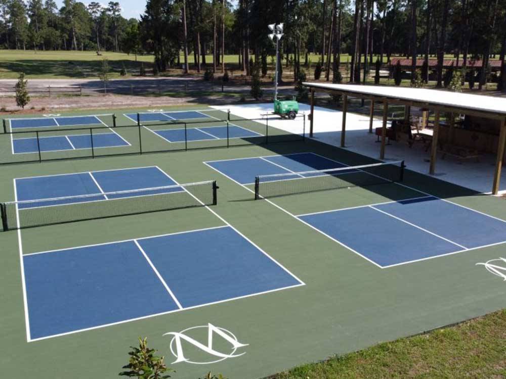 Pickleball courts with shaded pavilion at MADISON RV & GOLF RESORT