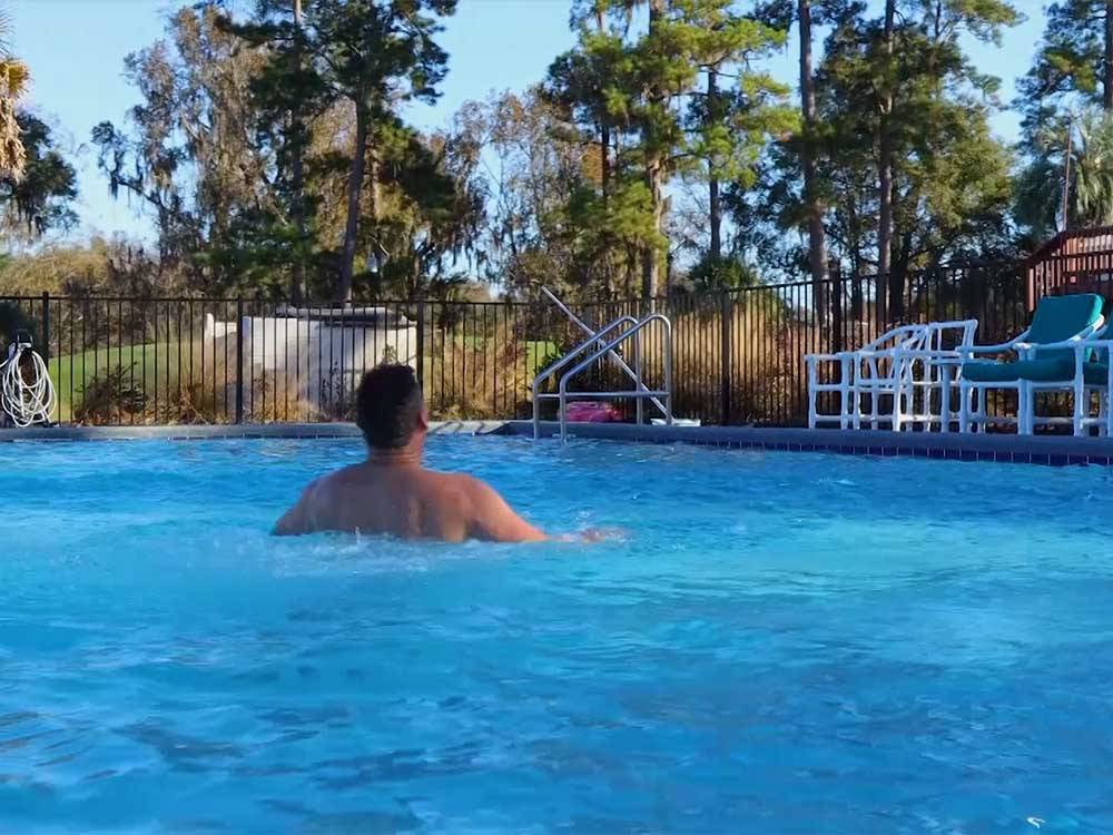 Man swimming in pool at MADISON RV & GOLF RESORT