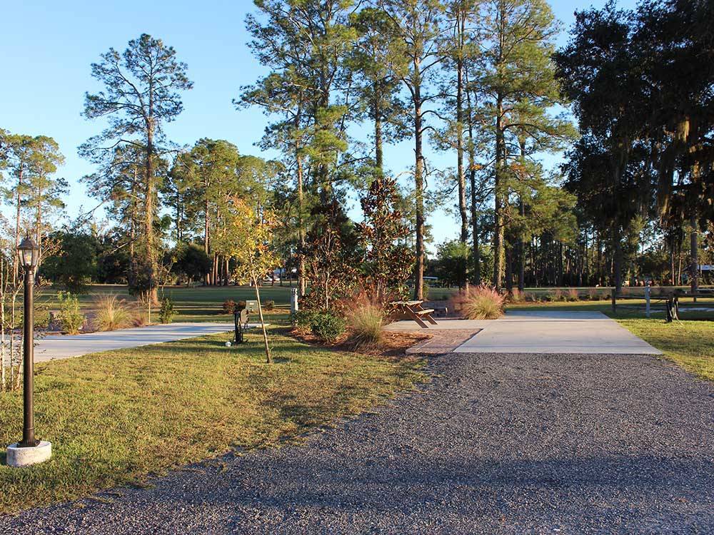 Paved site with a picnic bench at MADISON RV & GOLF RESORT