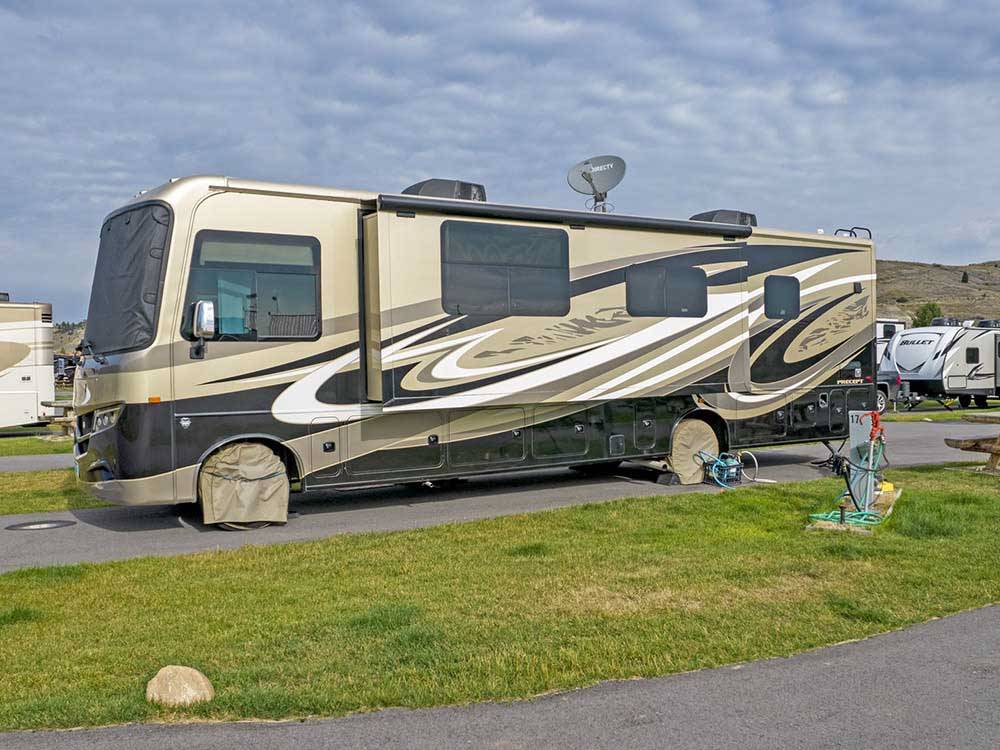 A motorhome parked in a paved site at COPPER COURT RV PARK