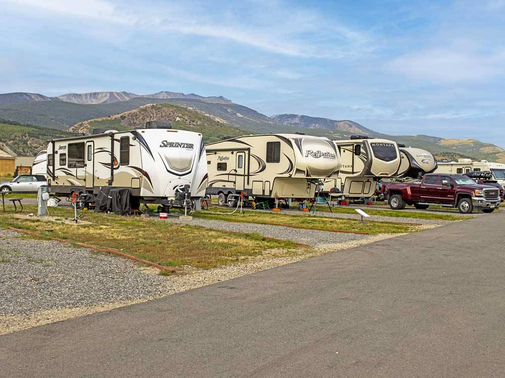 A row of trailers and fifth wheels in sites at COPPER COURT RV PARK