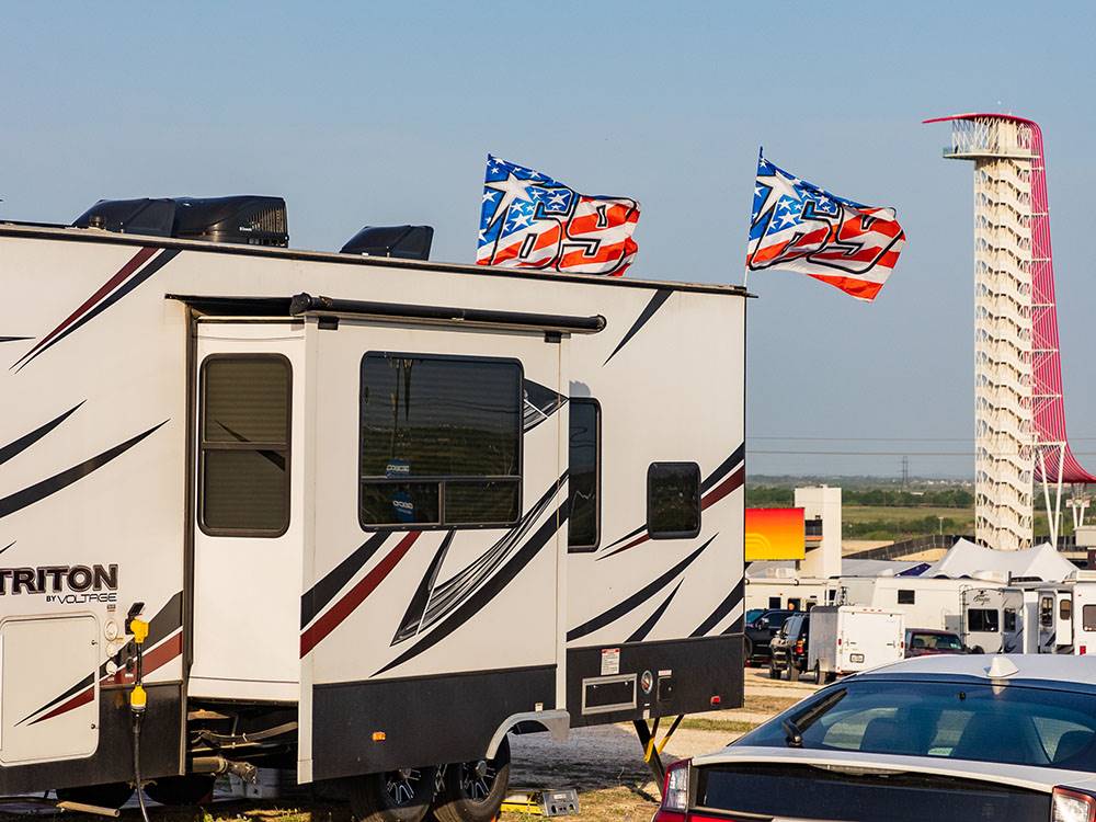 A trailer with two racing flags at COTA CAMPING-PREMIUM RV PARK