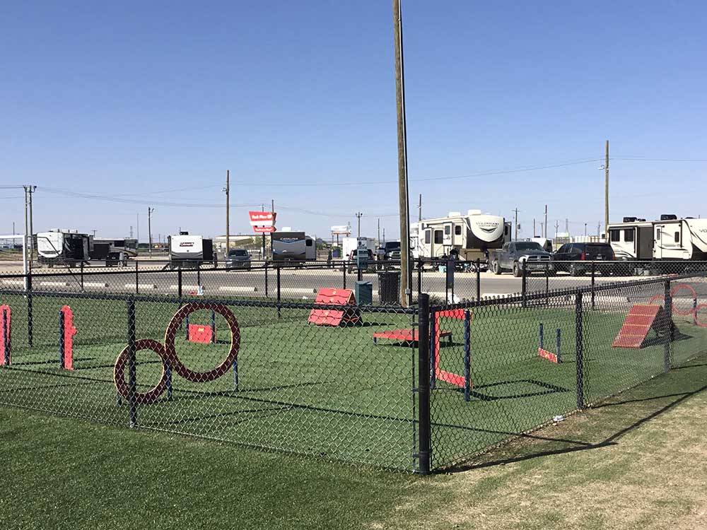 Dog park with obstacles at PARK PLACE RV RESORT