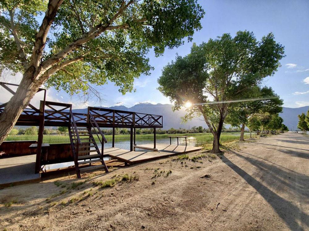 A deck on lake under trees